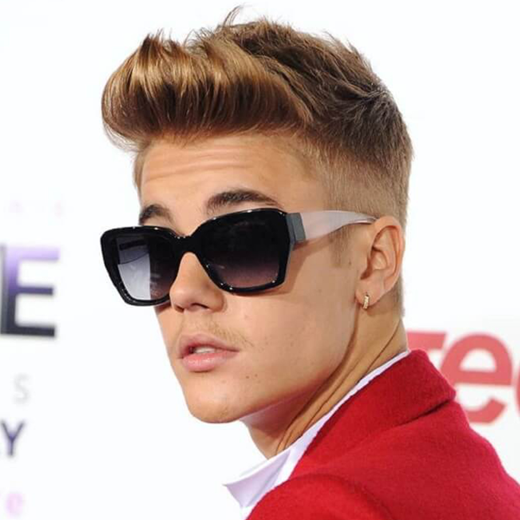 Justin Bieber showcasing a messy faux undercut hairstyle with a carefree and edgy vibe.