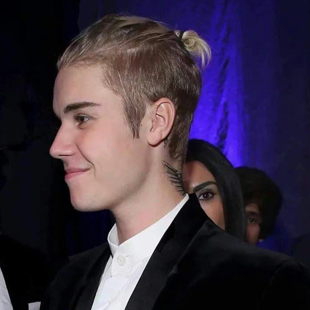 Justin Bieber flaunting a messy low bun hairstyle with a casual and relaxed appeal.