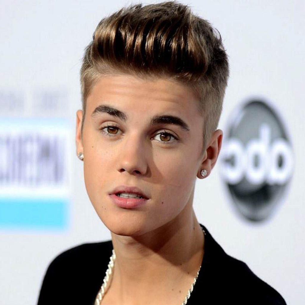 Justin Bieber showcasing a Mohawk hairstyle with colored tips for a vibrant and playful look.