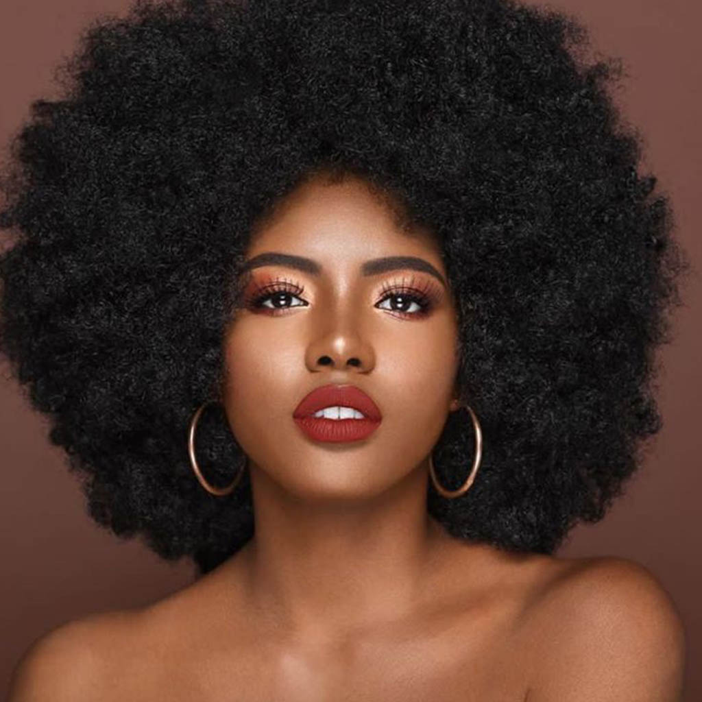  An empowering Women Cute Hairstyles embracing her natural beauty with an Afro-textured hairstyle.