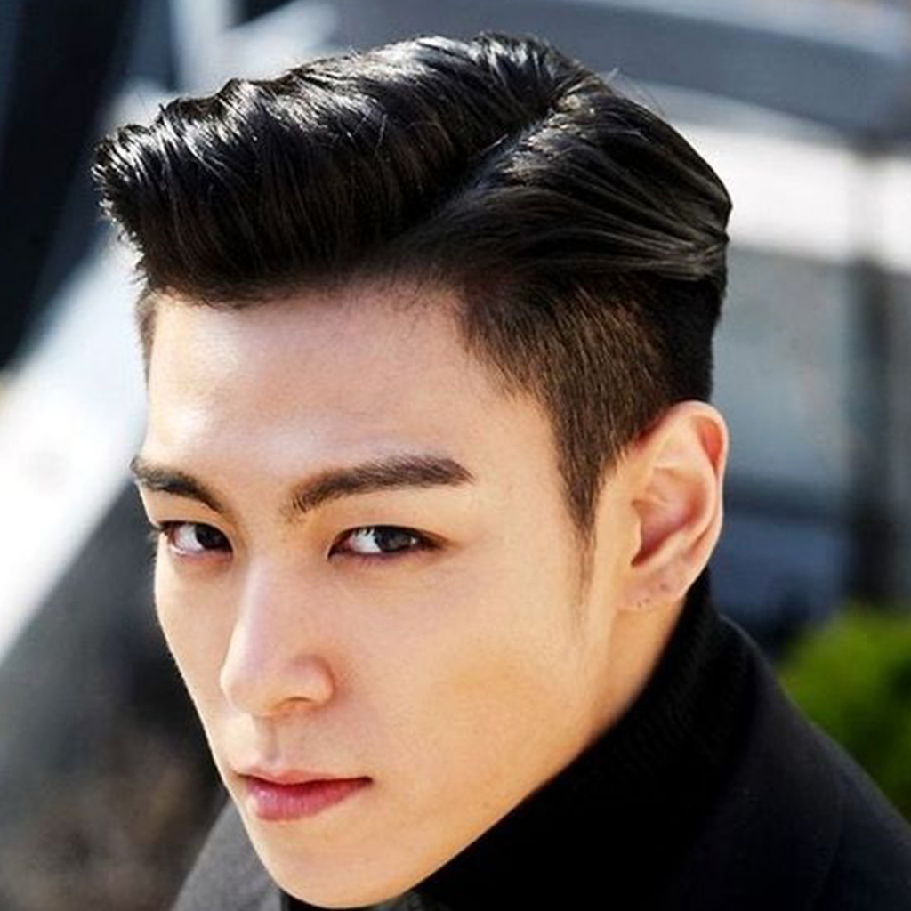 Korean man with a sleek side part hairstyle
