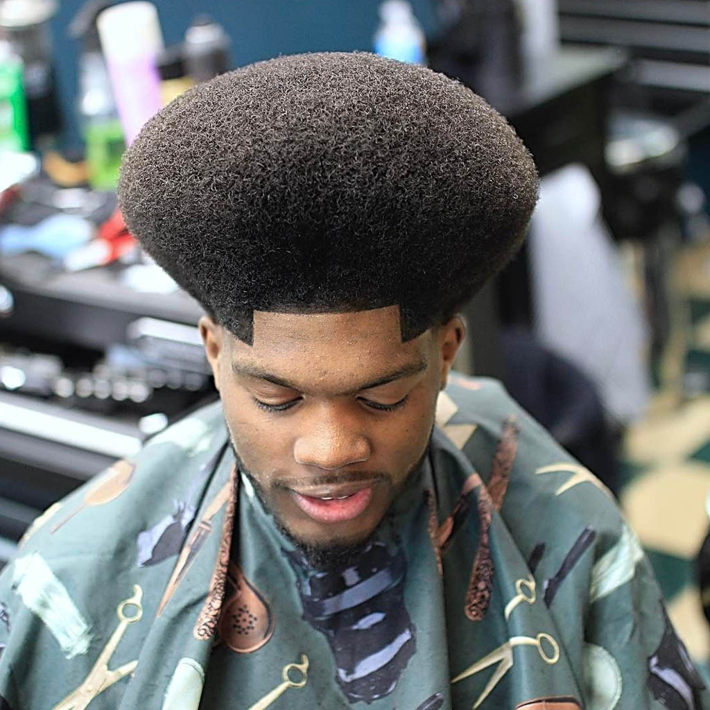 Man with an afro hairstyle, showcasing a voluminous and natural look.