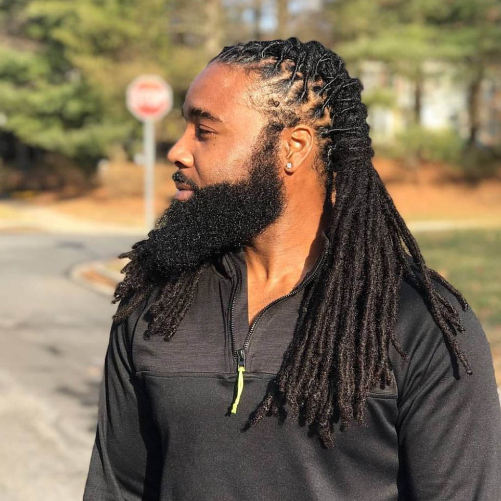 A man with dreadlocks hairstyle, showcasing long, naturally formed locks with a striking and textured appearance.