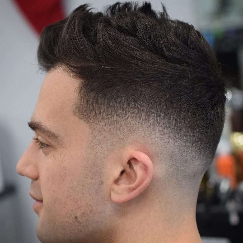 The Faux Hawk Fade - A modern twist on the classic Mohawk with a faded undercut.