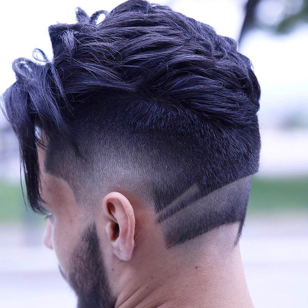 A man with a shaved hairstyle featuring a geometric design on the side or back of the head for a bold and artistic look.