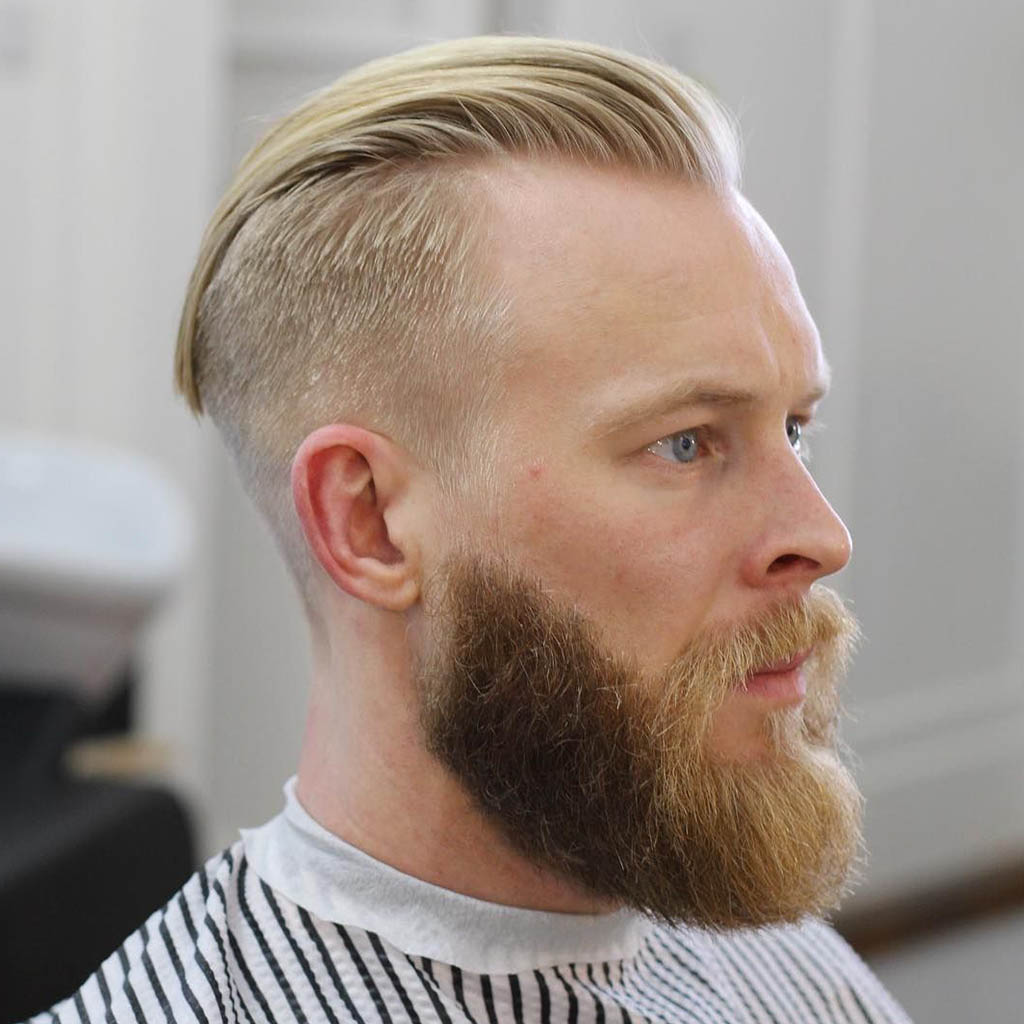 A man with a Wolf Cut featuring a slicked-back undercut, combining sleekness and edginess