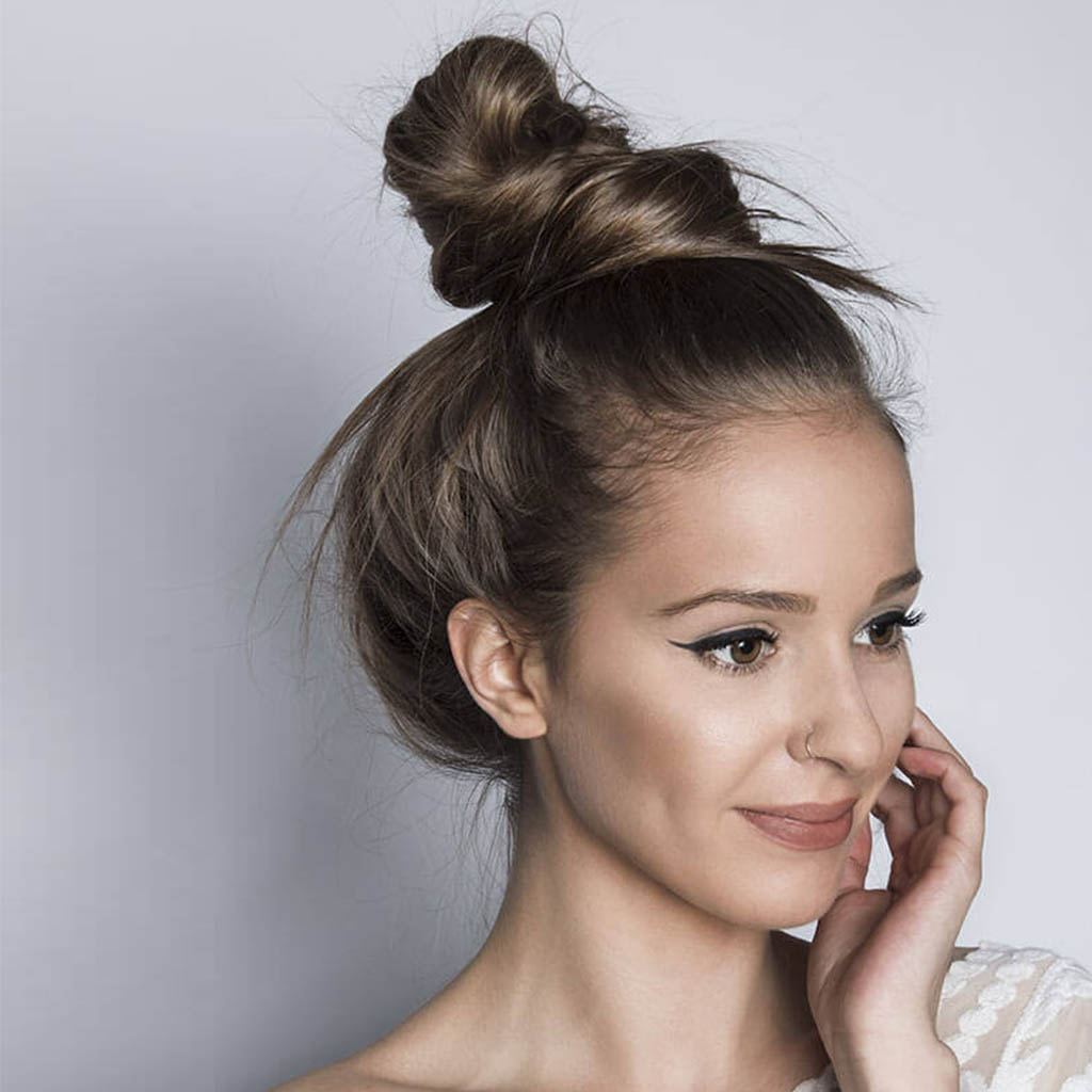 Chic messy bun for a relaxed yet stylish appearance.
