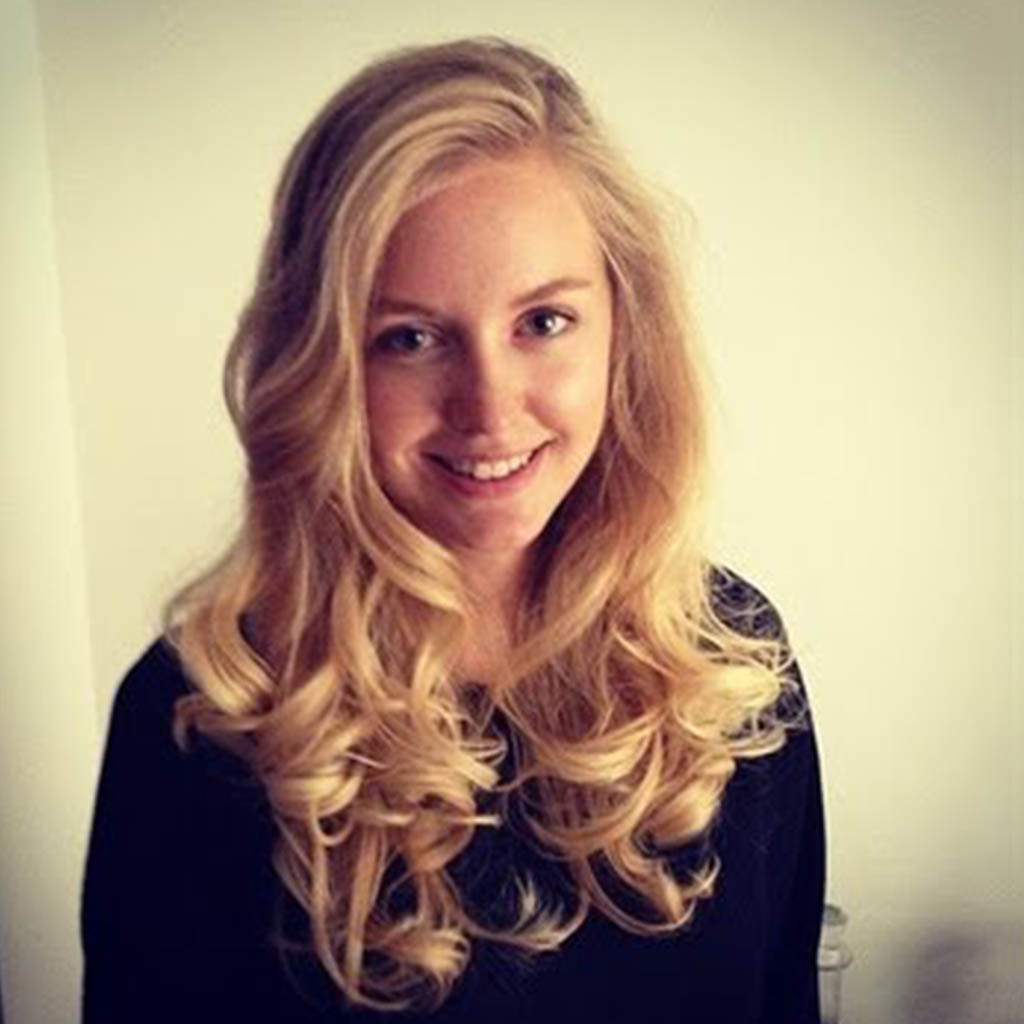 Woman with bouncy curls using a curling iron.