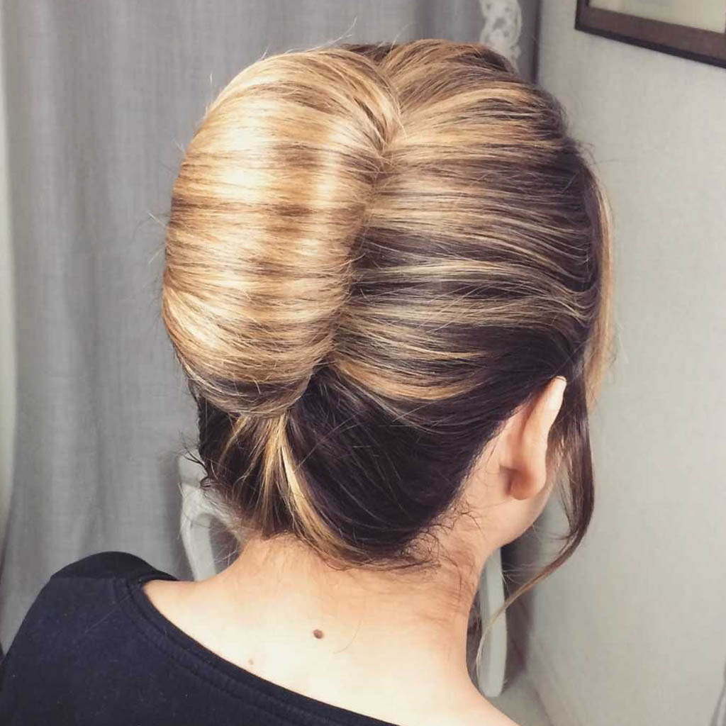 A woman with a classic French twist hairstyle.