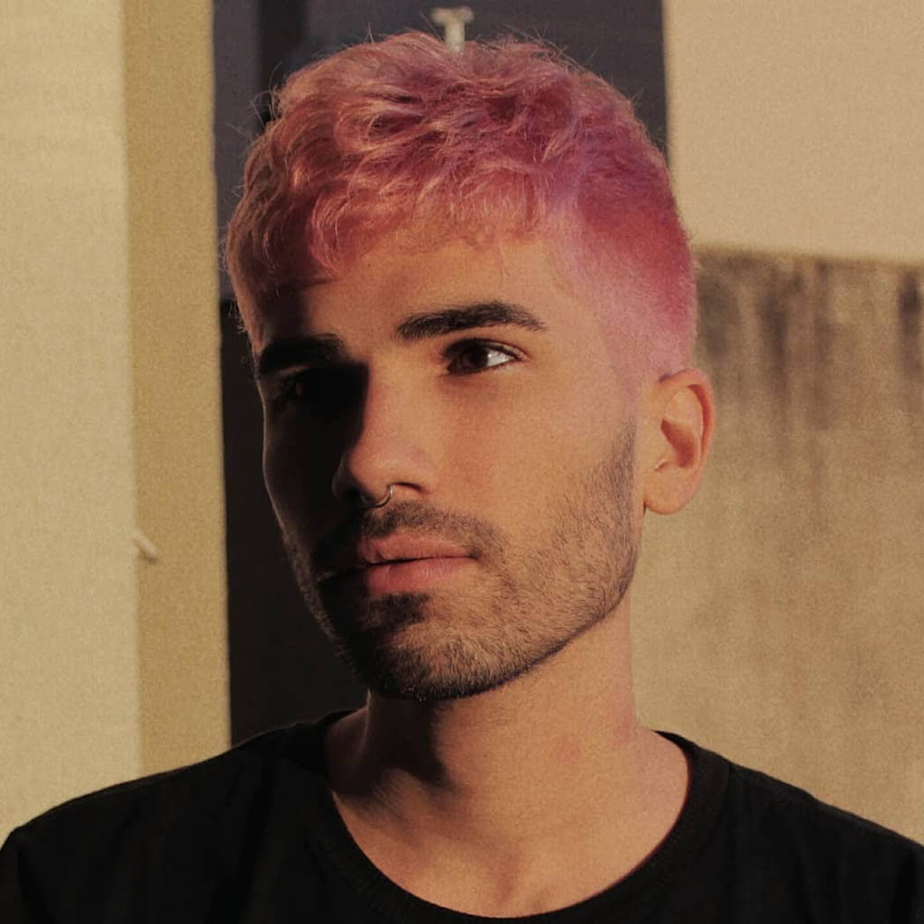 A man with a lavender undercut, flaunting a unique and trendy appearance.