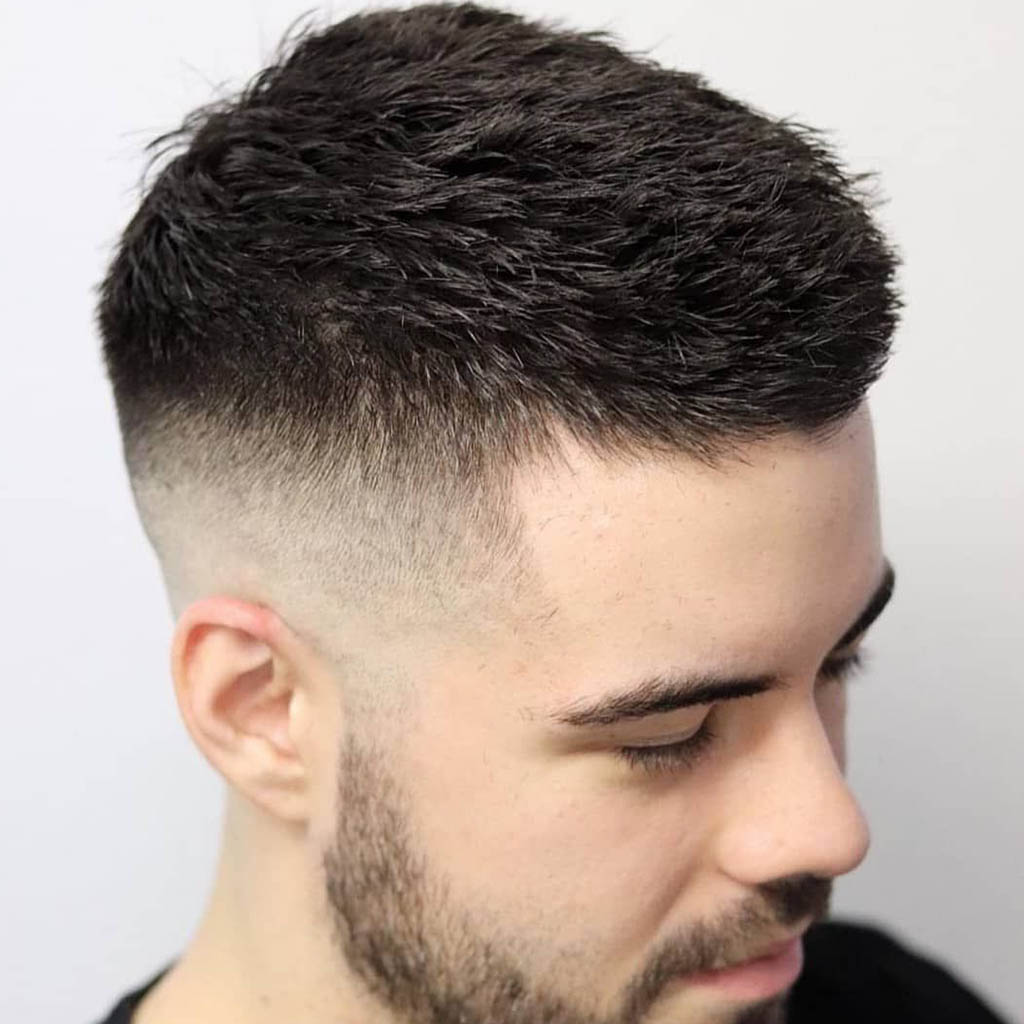 Fade haircut with textured volume on top.