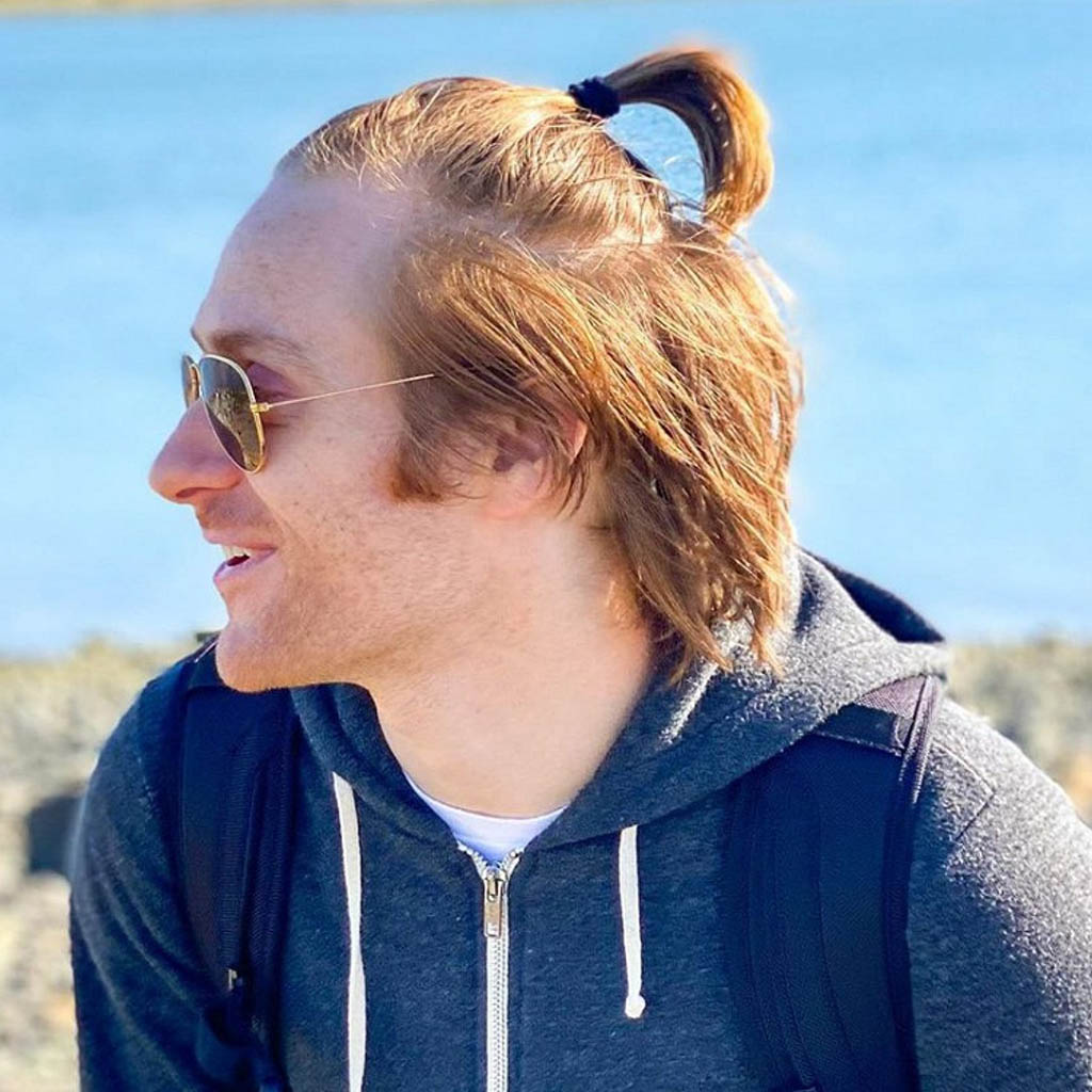 Man with an effortless low ponytail Hairstyles For Long Hair