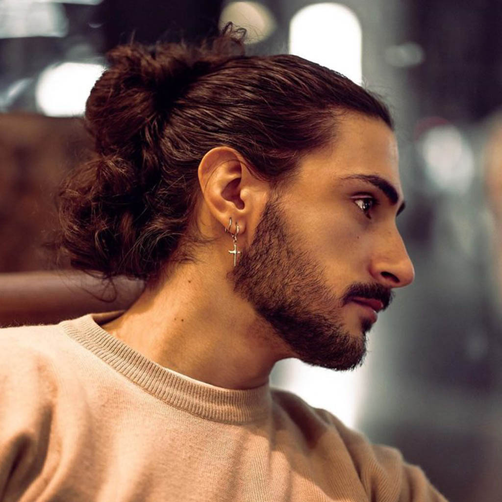 Man with a textured messy bun hairstyle