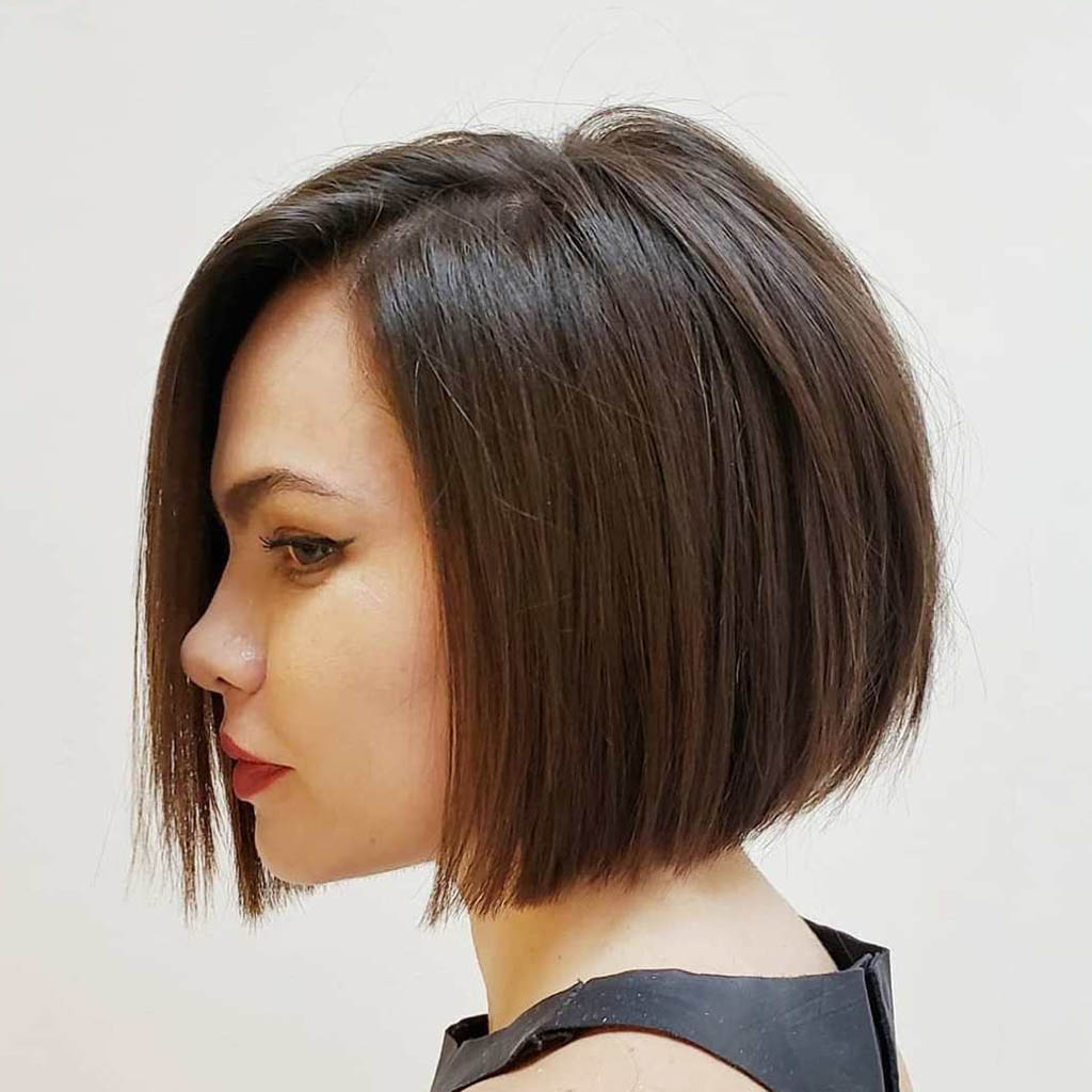 A flaunting a sharp and sleek blunt hair cut for woman, showcasing modern sophistication.