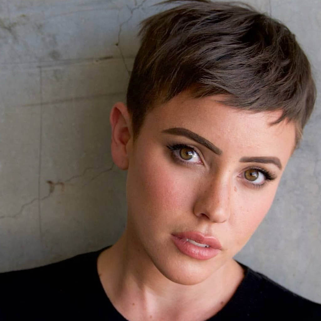 A woman showcasing a textured pixie cut with attitude.
